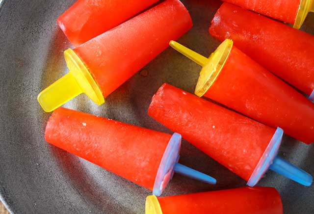 Easy Popsicles are a simple 2-ingredient pop recipe that's sure to cool you down through these hot summer months. So simple the kids can make them all on their own. Definitely a summertime favorite!