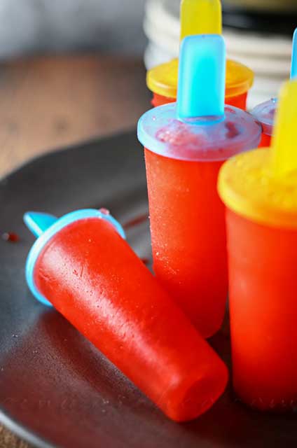 Easy Popsicles are a simple 2-ingredient pop recipe that's sure to cool you down through these hot summer months. So simple the kids can make them all on their own. Definitely a summertime favorite!