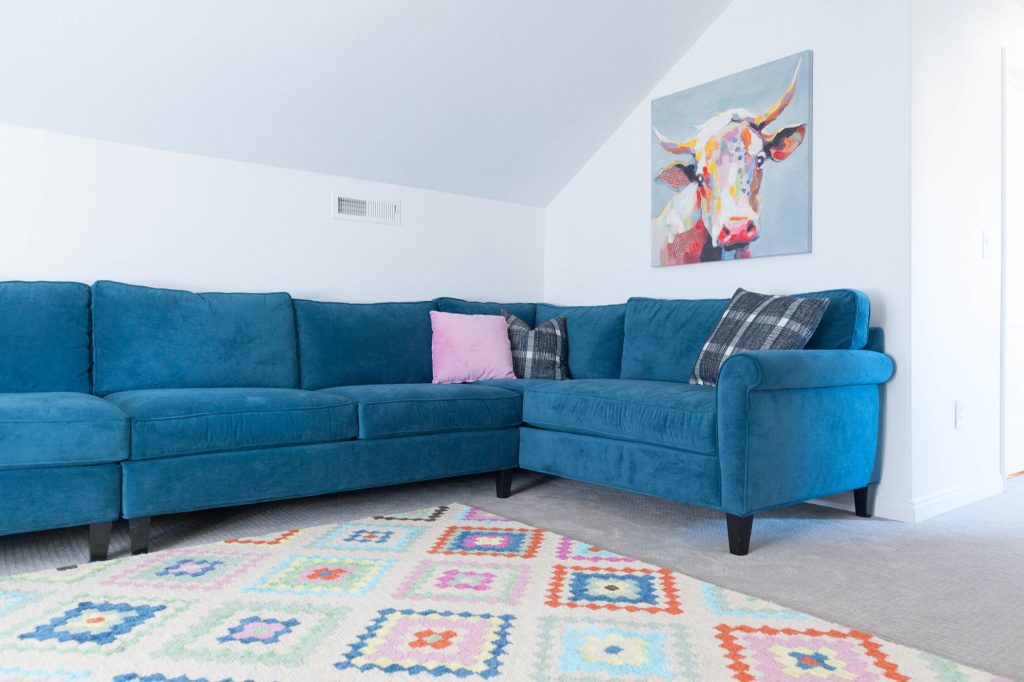 Navy or Dark Teal Sectional Couch in multi colored kids play room
