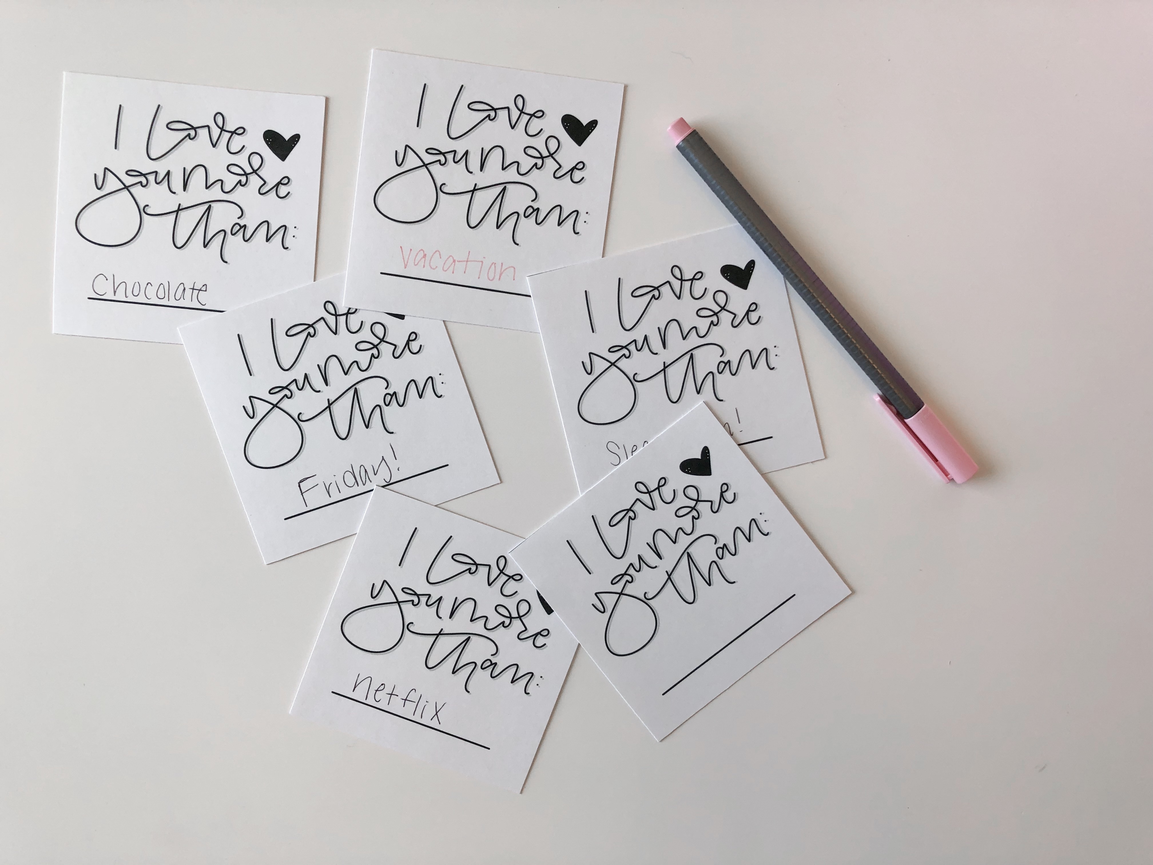 A set of 6 customizable love notes on a white desk